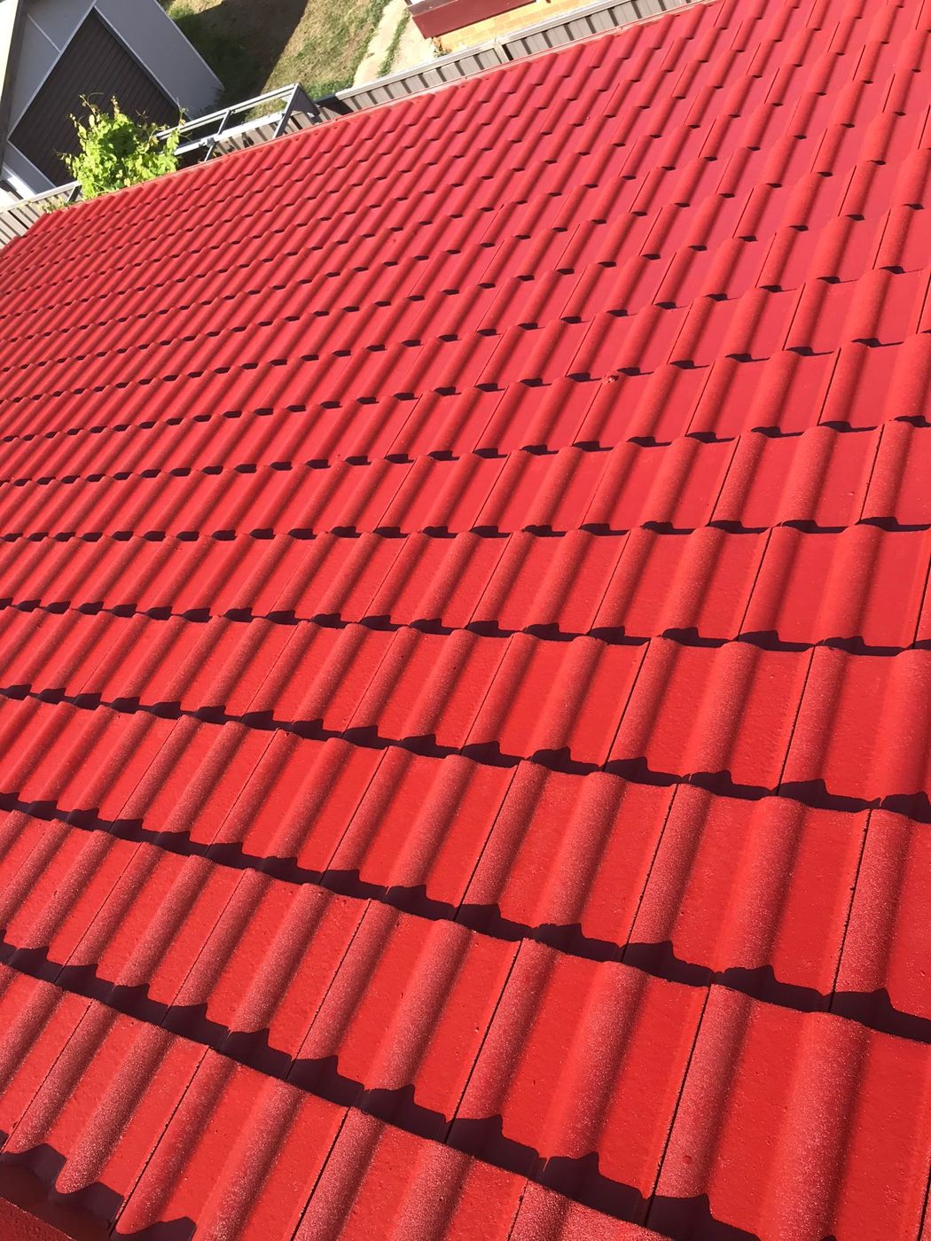 A roof freshly painted in terracotta red