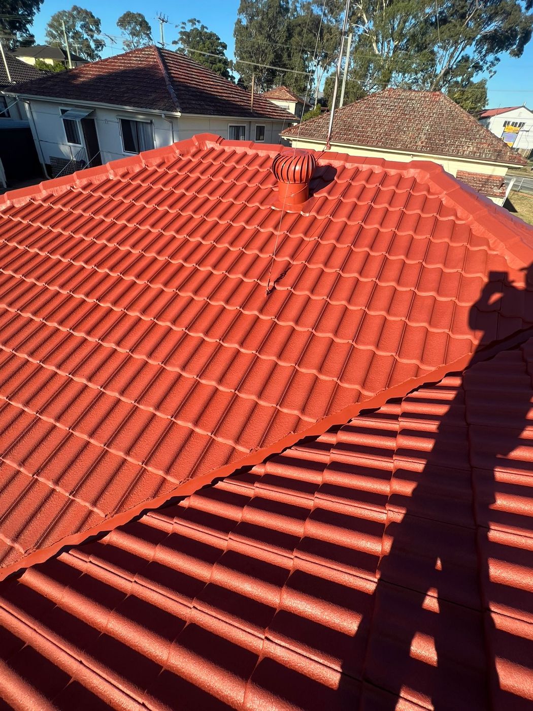 A tidy red tile roof after restoration